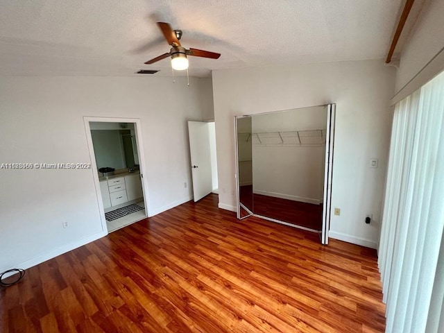 unfurnished bedroom with ceiling fan, light hardwood / wood-style floors, a textured ceiling, and a closet