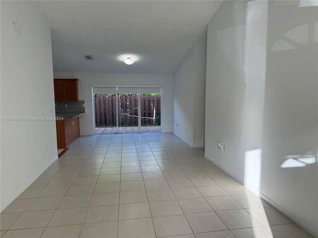 unfurnished living room with light tile patterned flooring