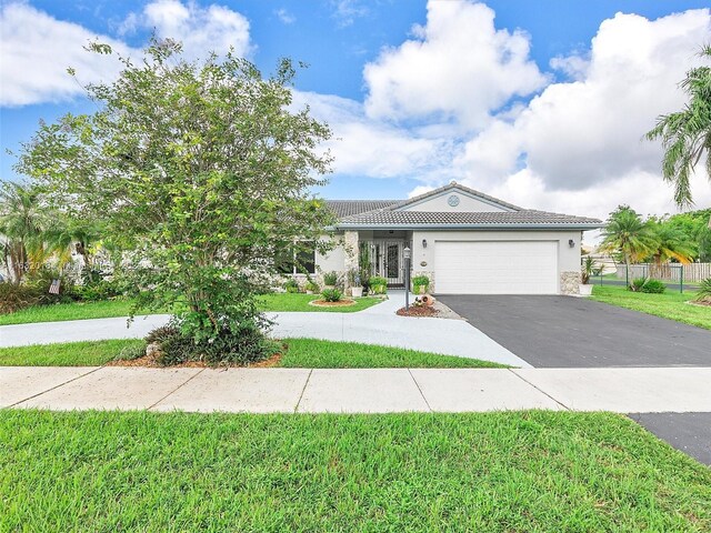 view of front of home featuring a garage and a front lawn