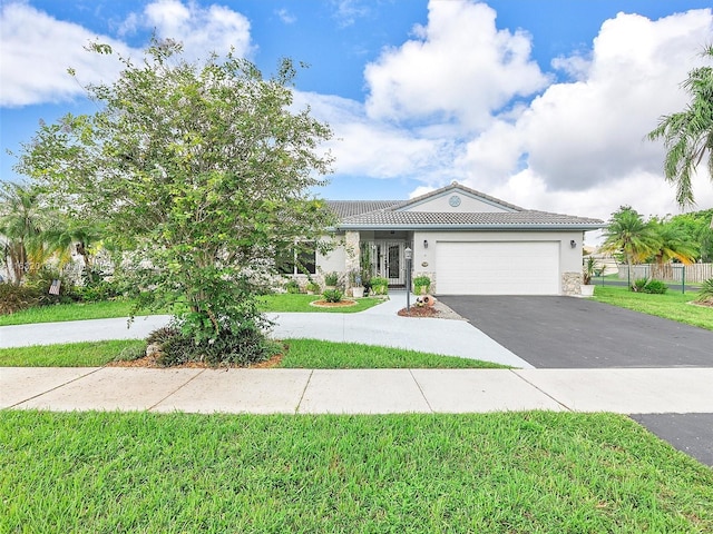 view of front of home featuring a garage and a front yard