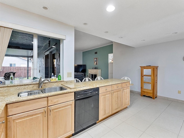 kitchen with black dishwasher, sink, and light brown cabinets