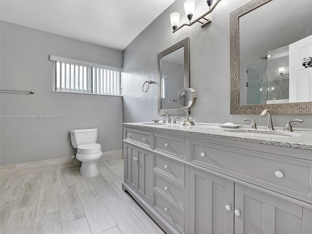 bathroom featuring vanity, toilet, and an enclosed shower