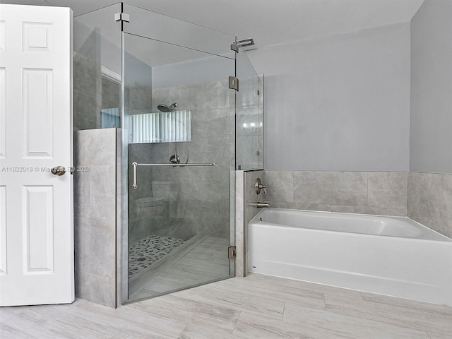 bathroom featuring independent shower and bath