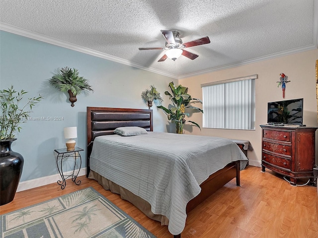 bedroom featuring ornamental molding, ceiling fan, and light hardwood / wood-style floors