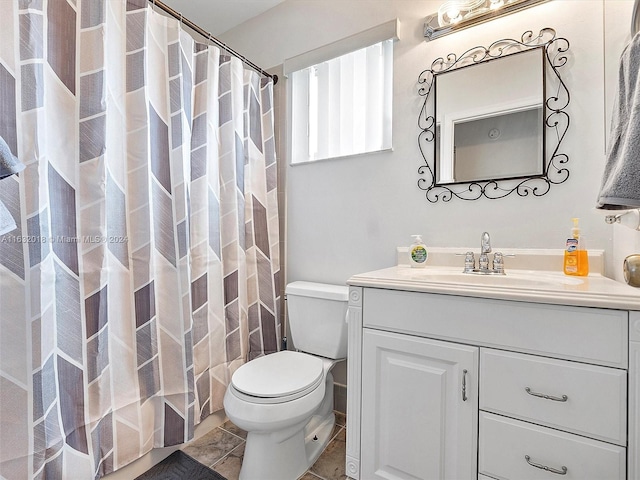 bathroom featuring a shower with curtain, tile patterned floors, vanity, and toilet