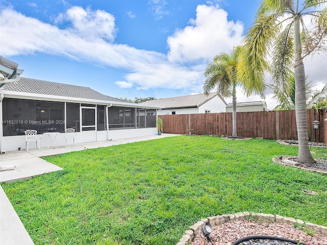 view of yard with a sunroom and a patio