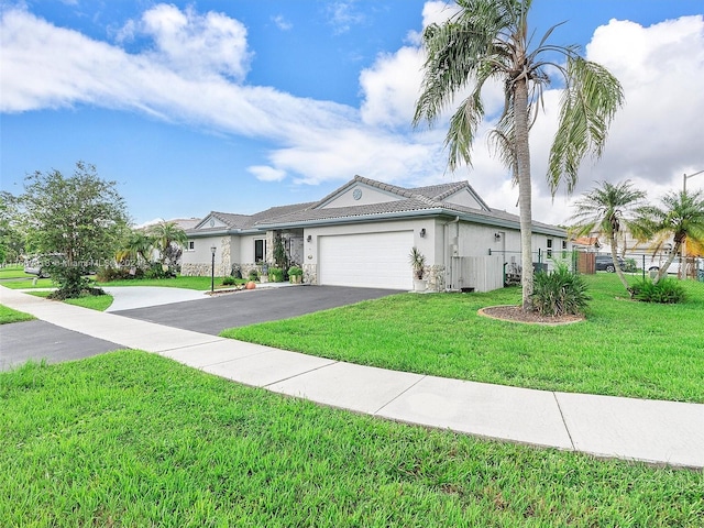 view of front of home featuring a garage and a front yard