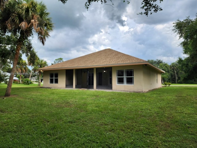 back of property featuring a yard