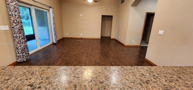 empty room with ceiling fan and a high ceiling