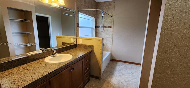 bathroom featuring tiled shower / bath combo and vanity