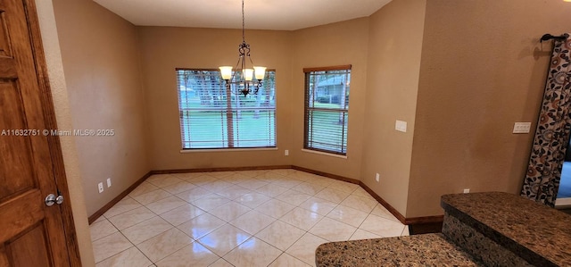 dining space featuring light tile patterned floors and an inviting chandelier