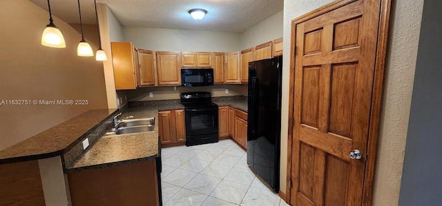 kitchen featuring kitchen peninsula, decorative light fixtures, a textured ceiling, black appliances, and sink