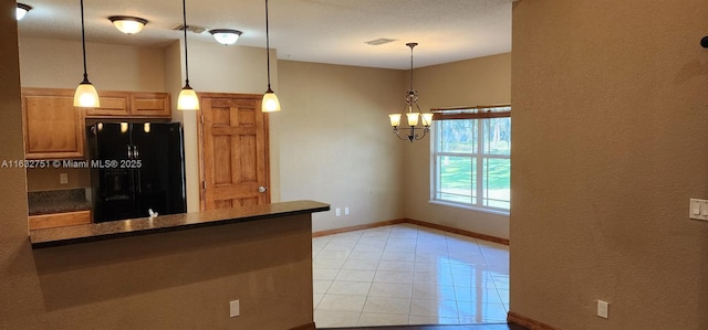 kitchen featuring an inviting chandelier, kitchen peninsula, decorative light fixtures, black refrigerator with ice dispenser, and light tile patterned flooring