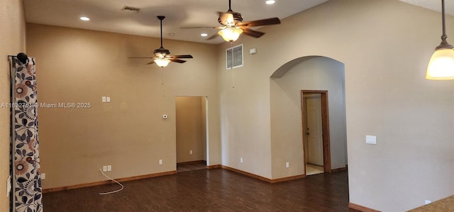 empty room featuring ceiling fan, dark hardwood / wood-style flooring, and high vaulted ceiling