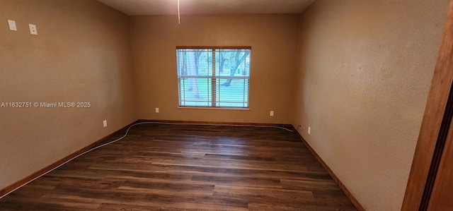 empty room featuring dark wood-type flooring