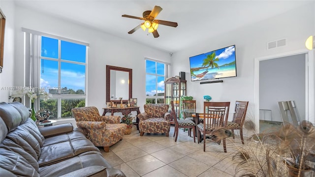 tiled living room featuring ceiling fan and visible vents