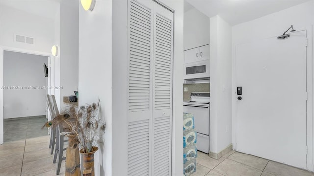 interior space with light tile patterned floors and visible vents