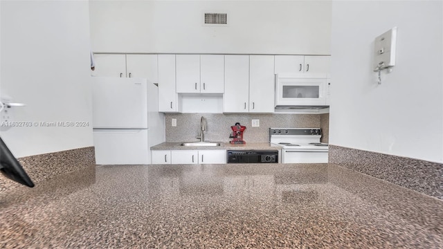 kitchen featuring white appliances, a sink, visible vents, and white cabinets