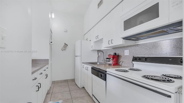 kitchen with white appliances, sink, decorative backsplash, light tile patterned flooring, and white cabinetry