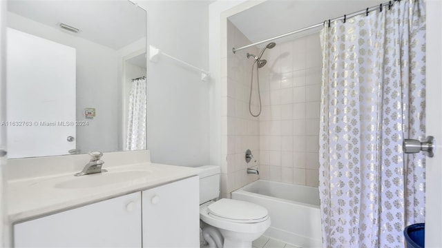 full bath featuring visible vents, toilet, tile patterned floors, shower / bath combo with shower curtain, and vanity