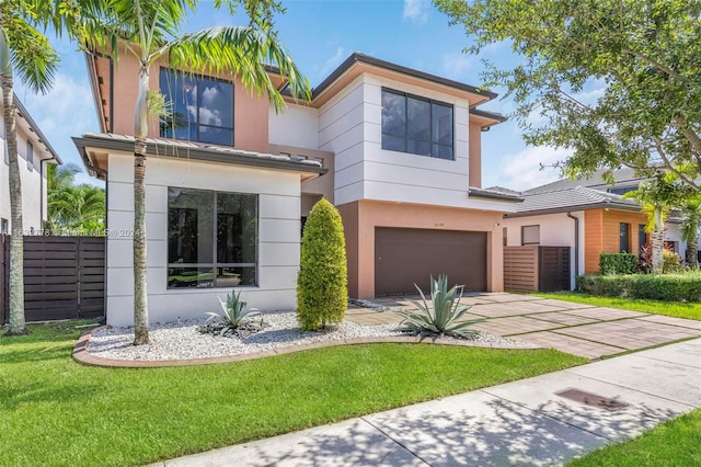 contemporary home featuring a garage and a front yard