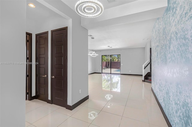 corridor featuring a chandelier and light tile patterned floors