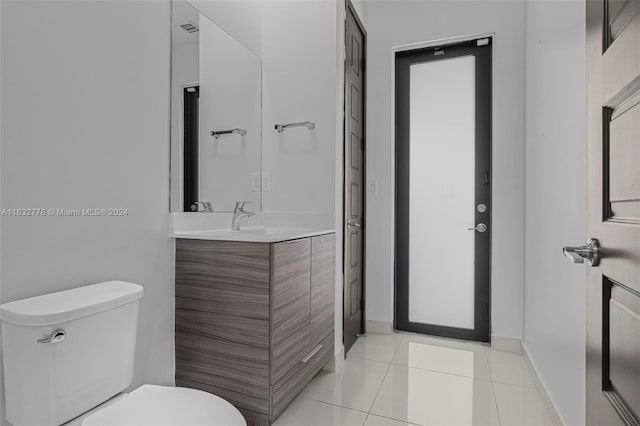 bathroom with vanity, toilet, and tile patterned floors