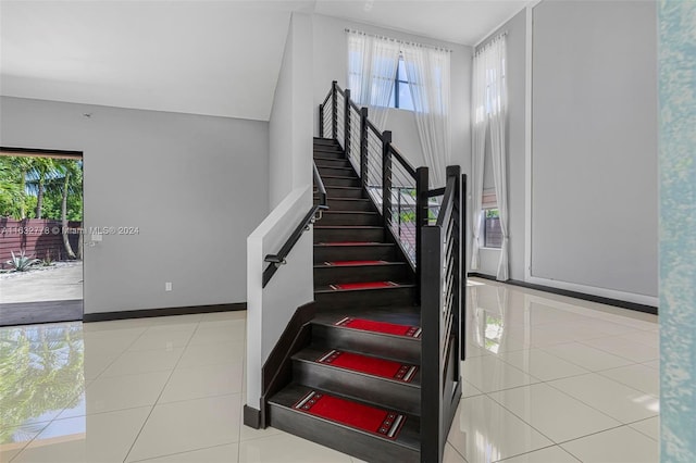 stairway featuring light tile patterned flooring