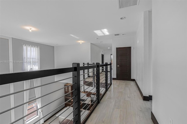 hallway with light hardwood / wood-style flooring