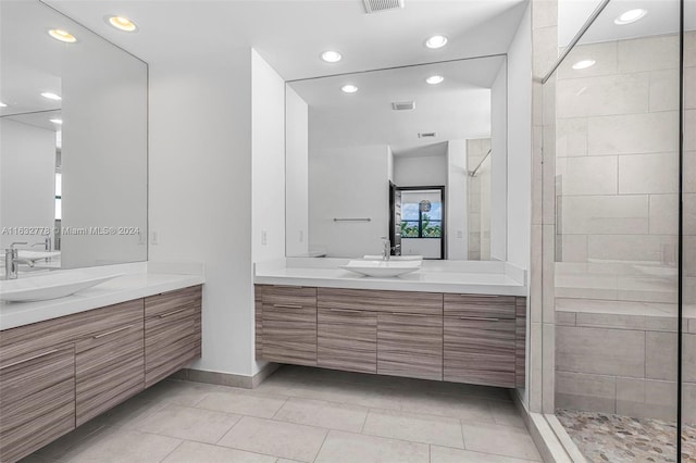 bathroom featuring tiled shower, vanity, and tile patterned floors