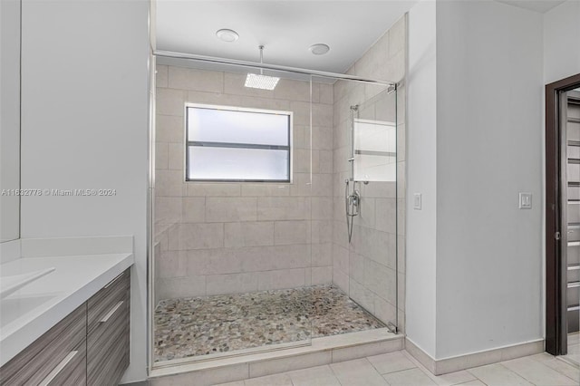 bathroom featuring tile patterned flooring, vanity, and an enclosed shower