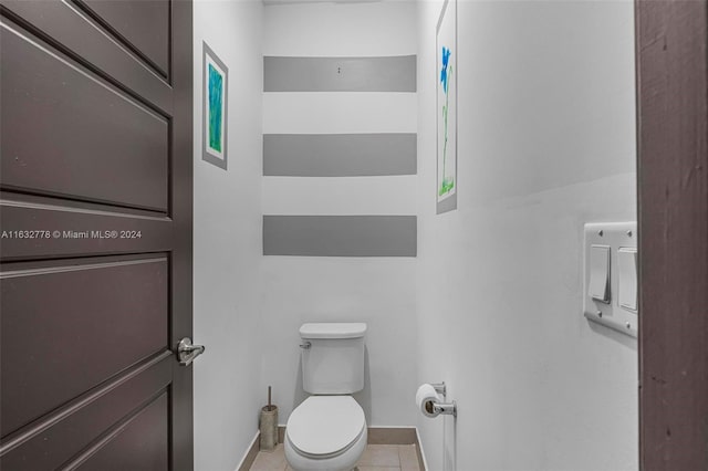 bathroom featuring tile patterned flooring and toilet