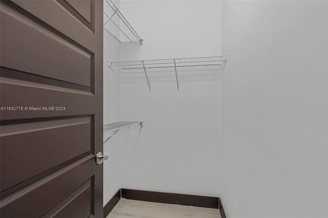 spacious closet featuring hardwood / wood-style flooring