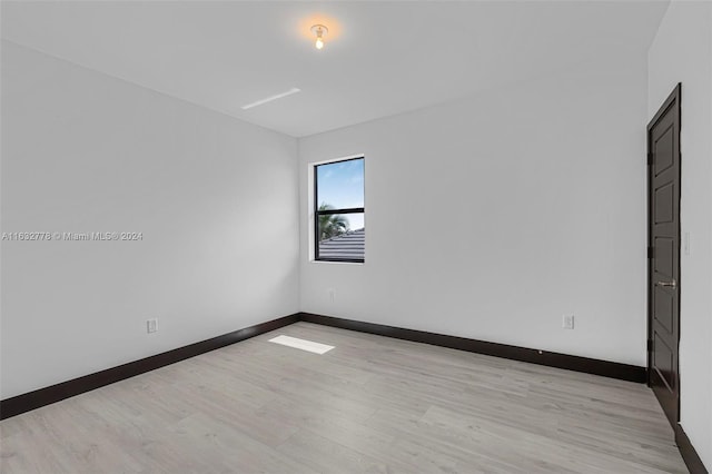 unfurnished room with light hardwood / wood-style floors