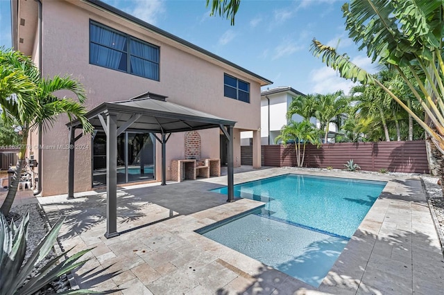 view of swimming pool with a patio and a gazebo