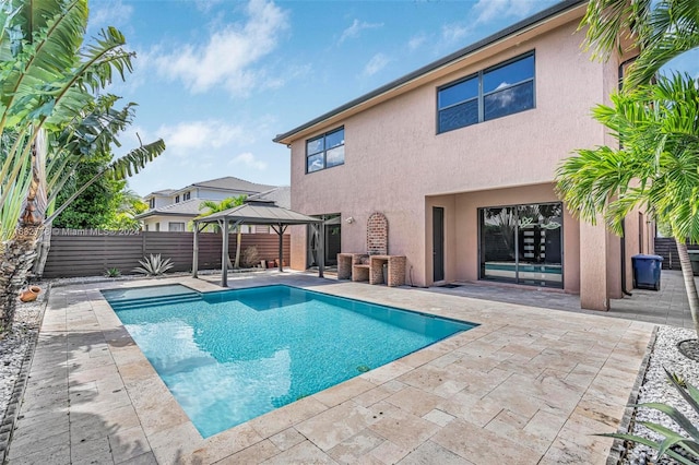 view of swimming pool featuring a patio and a gazebo