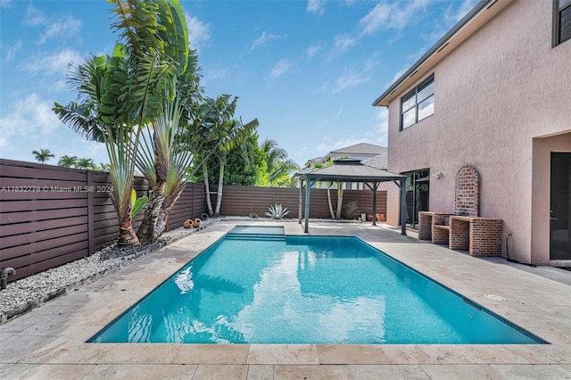 view of swimming pool with a patio and a gazebo