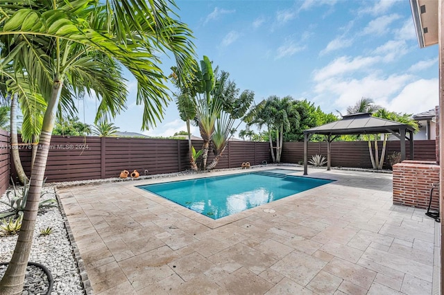 view of swimming pool with a patio and a gazebo