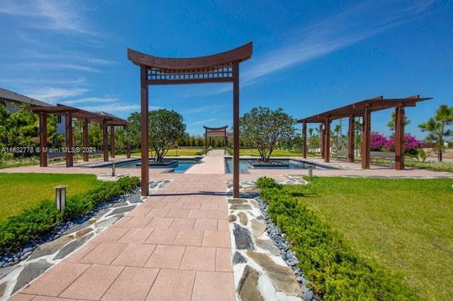 view of community featuring a gazebo, a swimming pool, a lawn, and a pergola