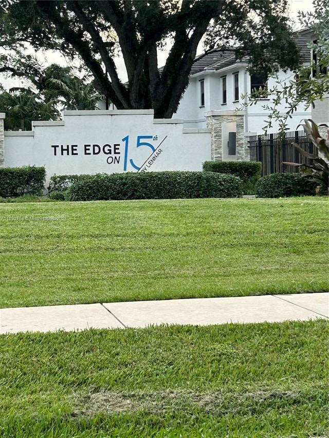 community sign featuring a lawn