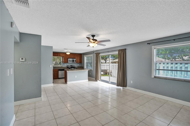 unfurnished living room featuring light tile patterned flooring, a textured ceiling, and ceiling fan