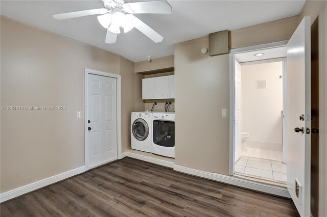 laundry room with washer and dryer, hardwood / wood-style floors, cabinets, and ceiling fan