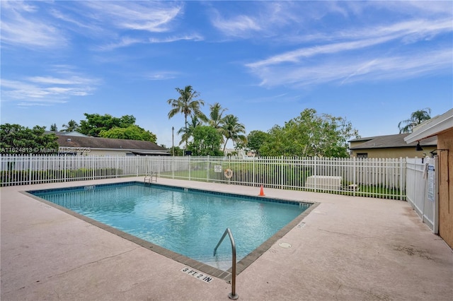 community pool featuring a patio area and fence