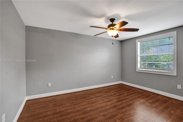 empty room featuring ceiling fan, baseboards, and wood finished floors