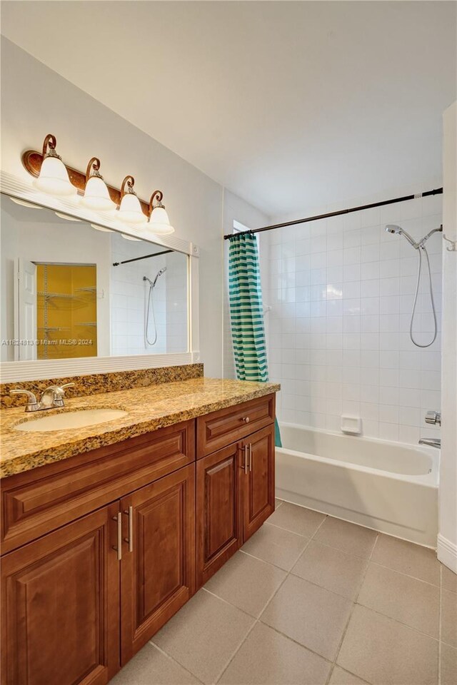 bathroom with shower / tub combo with curtain, vanity, and tile patterned floors