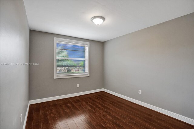 empty room with hardwood / wood-style flooring