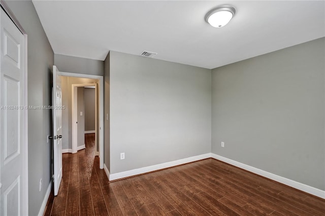 unfurnished bedroom with visible vents, baseboards, and wood finished floors