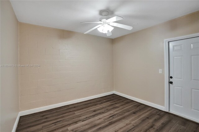 spare room featuring dark hardwood / wood-style flooring and ceiling fan