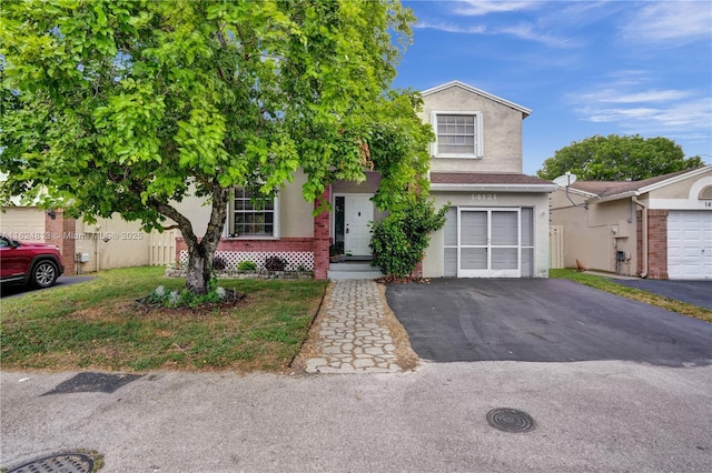 view of front of property featuring a garage, fence, aphalt driveway, and stucco siding