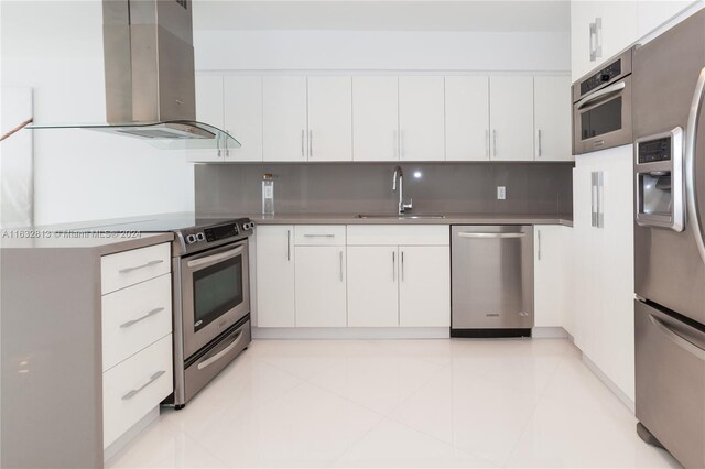 kitchen featuring stainless steel appliances, light tile patterned floors, white cabinets, ventilation hood, and sink